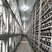 A photo inside a modern mining farm with rows of mining rigs.